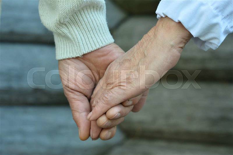 Portrait of a elderly couple holding hands close up, stock photo