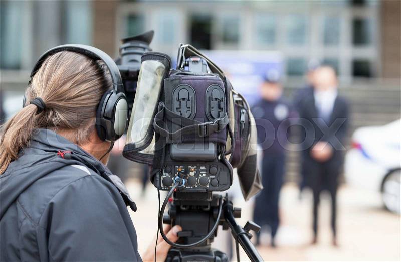 Cameraman. News conference. Filming an event with a video camera, stock photo