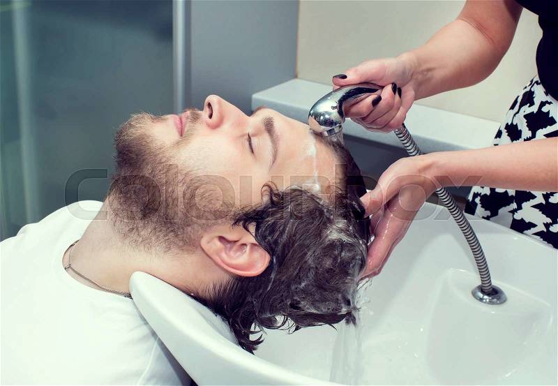 The young man at the hairdresser salon hairstyle make model, stock photo