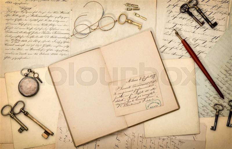 Open book, vintage accessories, old letters and postcards. Nostalgic paper background, stock photo