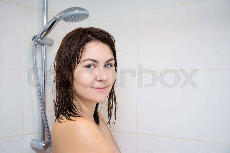 Young naked woman in bathroom, decollete, head and 