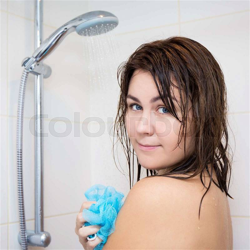 Hygiene concept - young beautiful woman washing her body with sponge in shower, stock photo