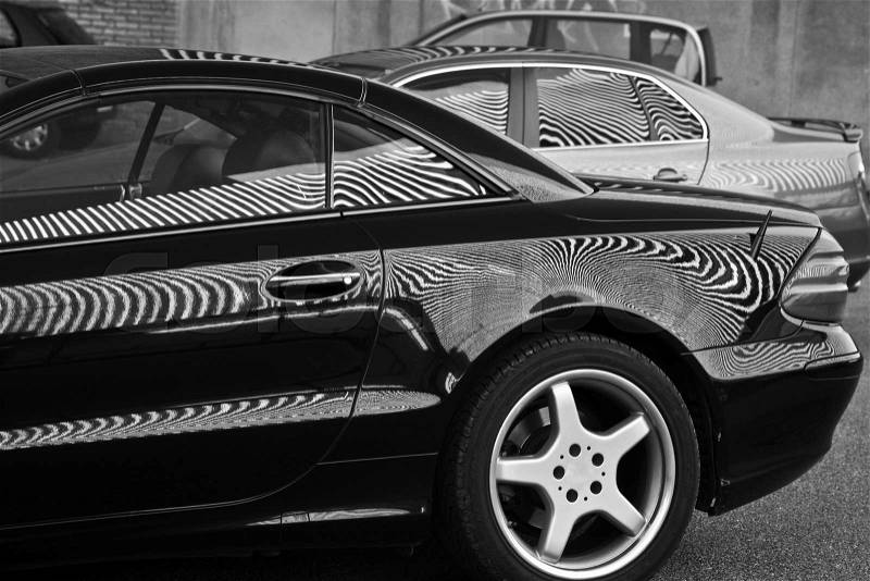 Car and stripes, car parked in front of a building with striped pattern, stock photo