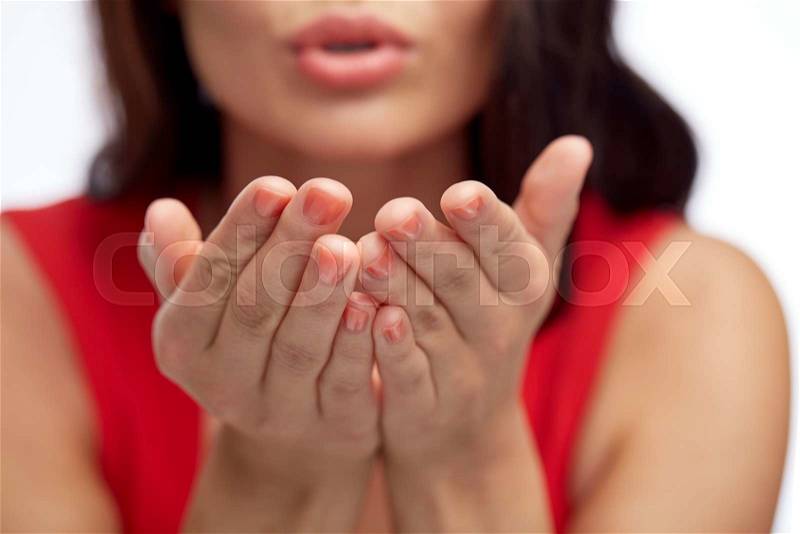 People and gesture concept - close up of woman hands sending blow kiss, stock photo