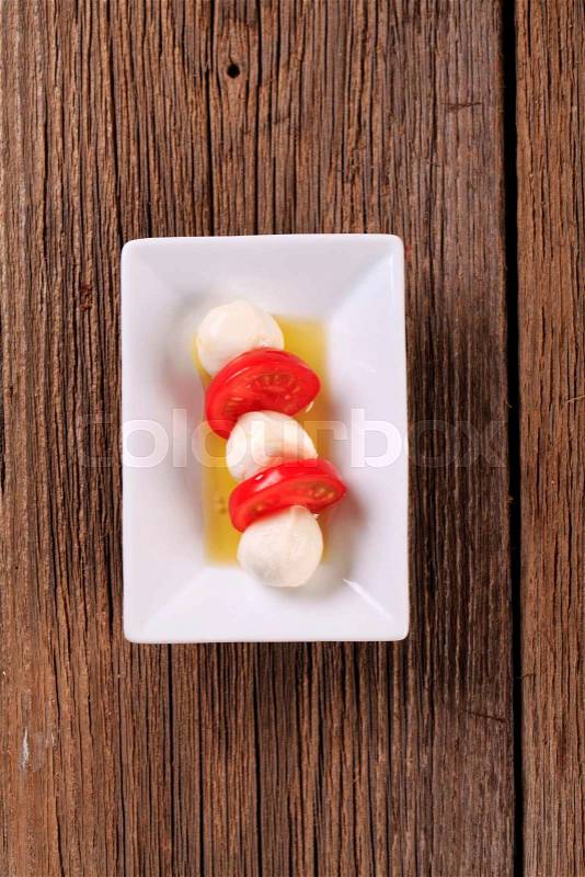 Marinated mozzarella cheese balls and fresh tomato, stock photo