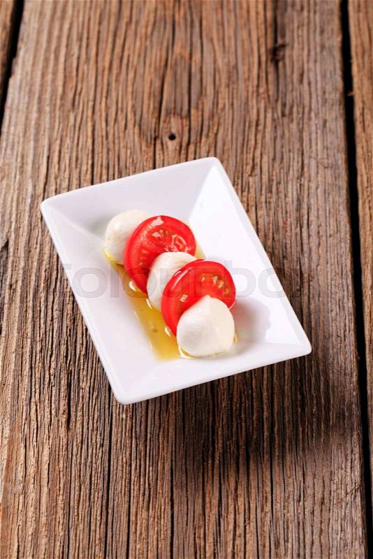 Marinated mozzarella cheese balls and fresh tomato, stock photo