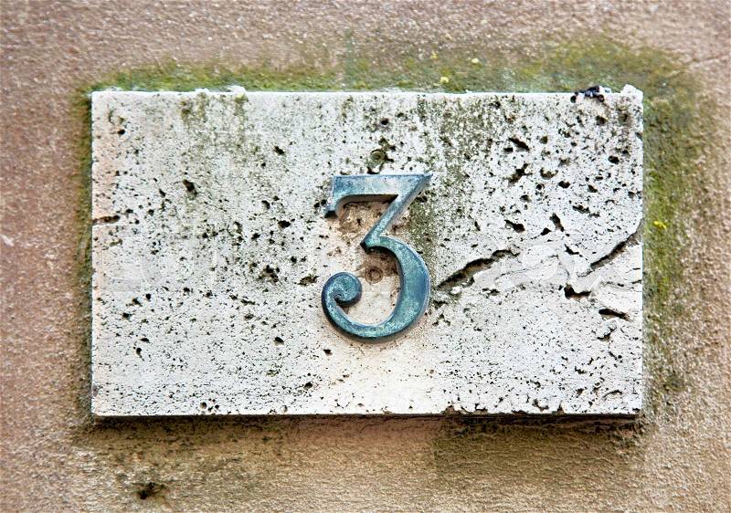 Block number on a weathered wall - detail, stock photo