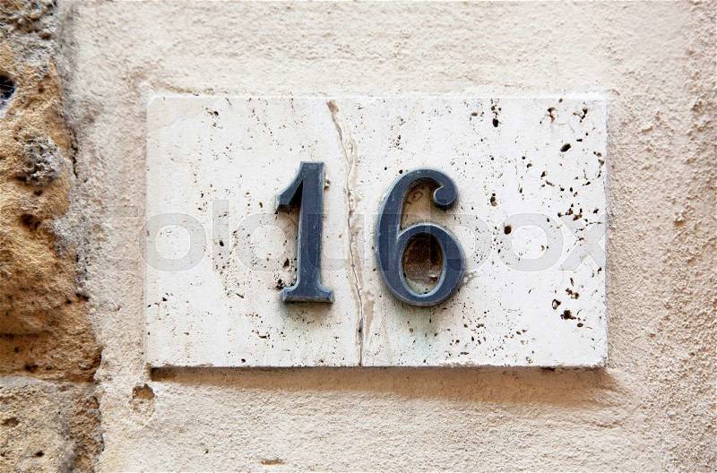 Block number on a weathered wall - detail, stock photo