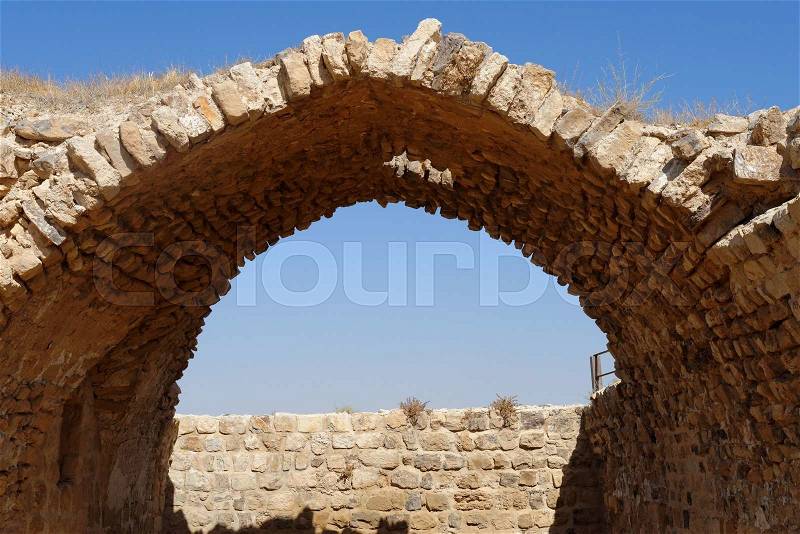 Ancient stone arch and wall of Kerak Castle in Jordan, stock photo