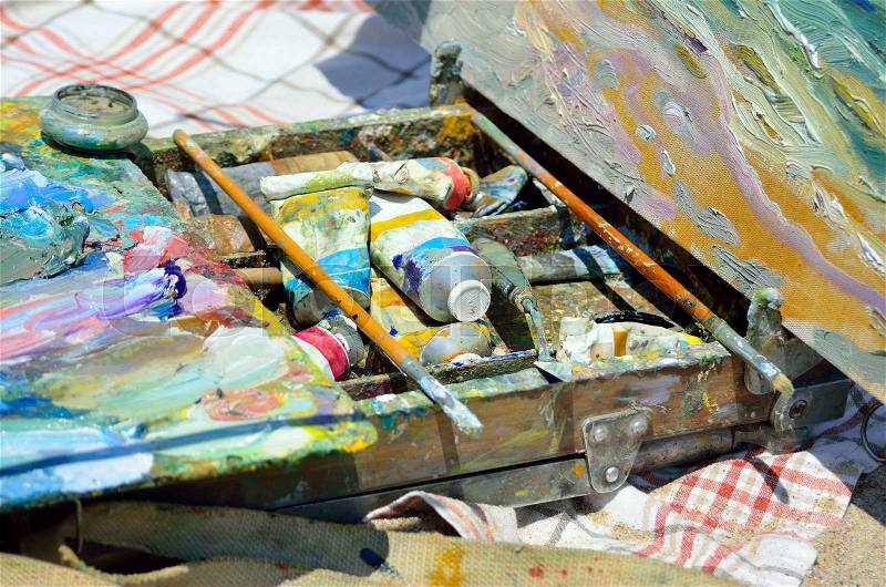 Artistic Brush lies on the palette with colorful paints, stock photo