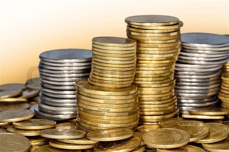 Folded stack of coins of yellow and white metal, stock photo