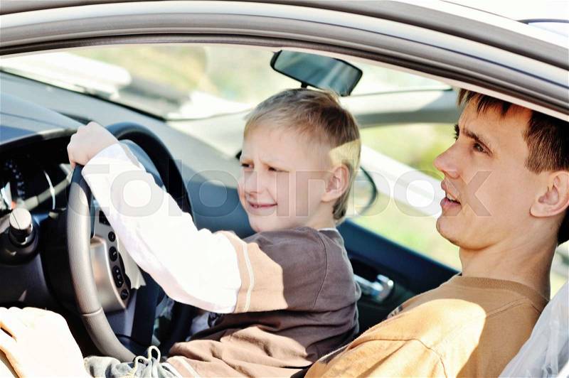 Father and son are sitting in a car, stock photo