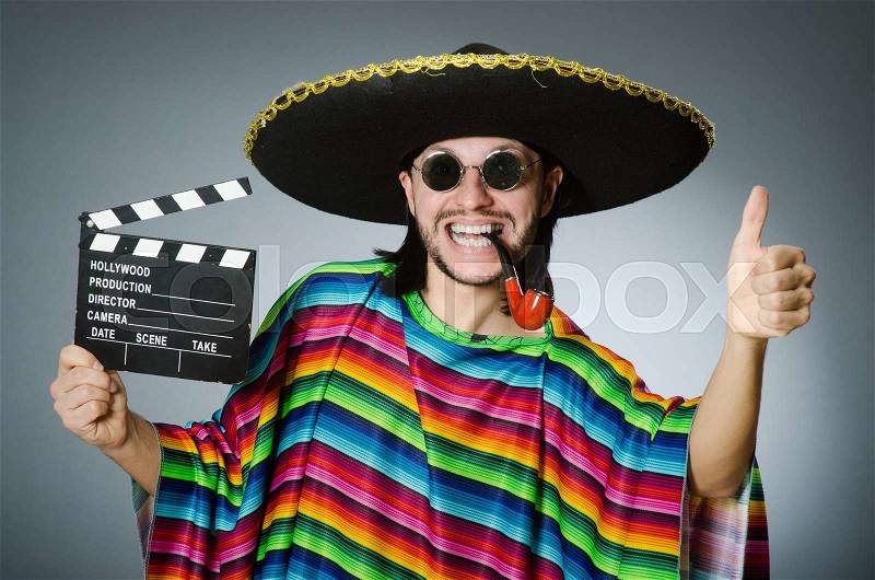 Mexican man with movie board, stock photo