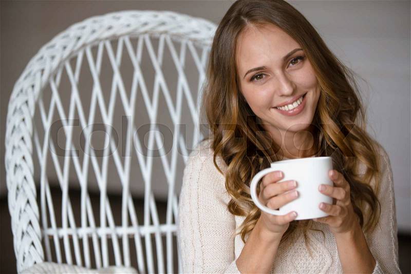 Girl portrait with cup of coffee at home, stock photo