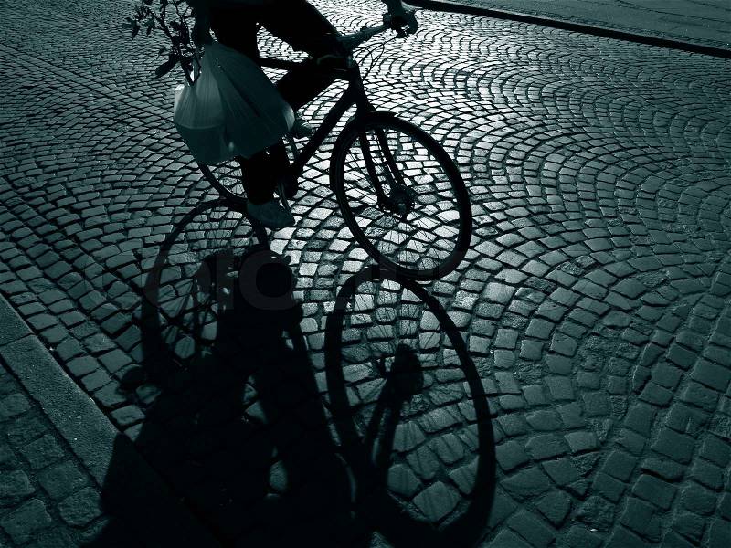 Late male cyclist with rose on his way home - Denmark, stock photo