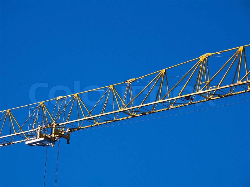 Detail of the jib of a yellow hoisting tower crane, stock photo