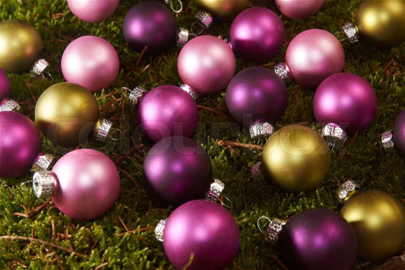 Colorful Christmas balls on green moss, stock photo