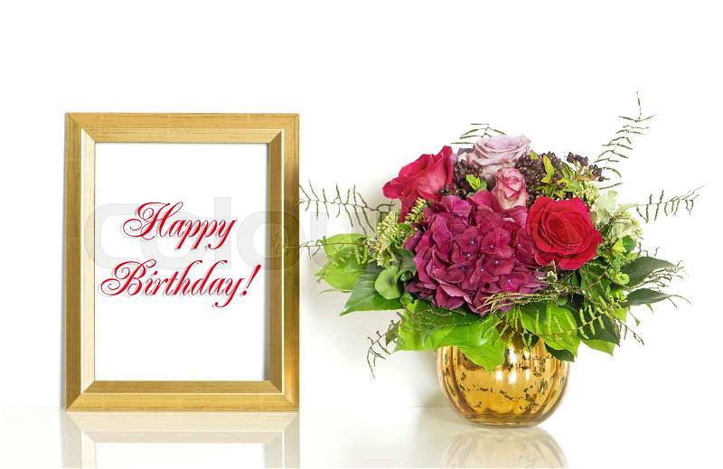 Bouquet of rose flowers and golden frame with sample text Happy Birthday!, stock photo