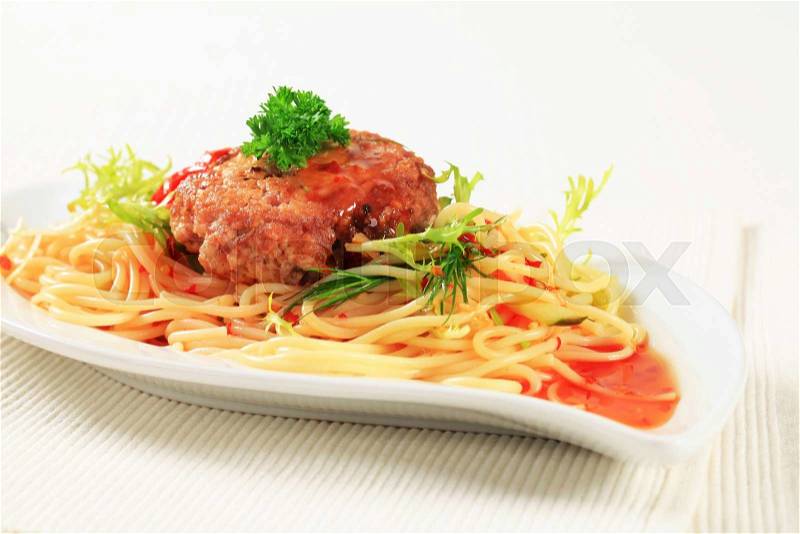 Meat patty with spaghetti and spicy sauce, stock photo
