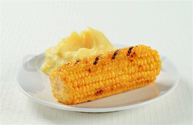Dish of grilled sweet corn with mashed potato , stock photo