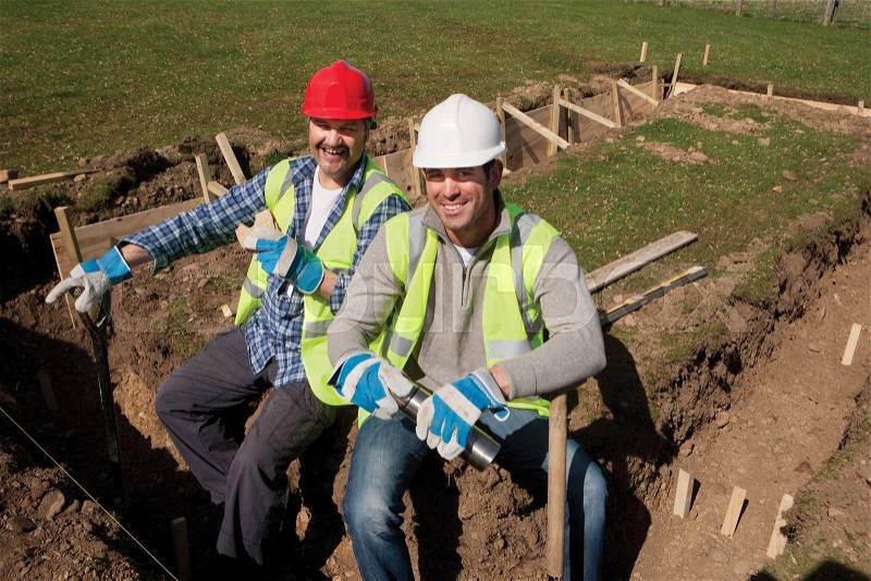 Two male construction workers having a lunch break together, stock photo