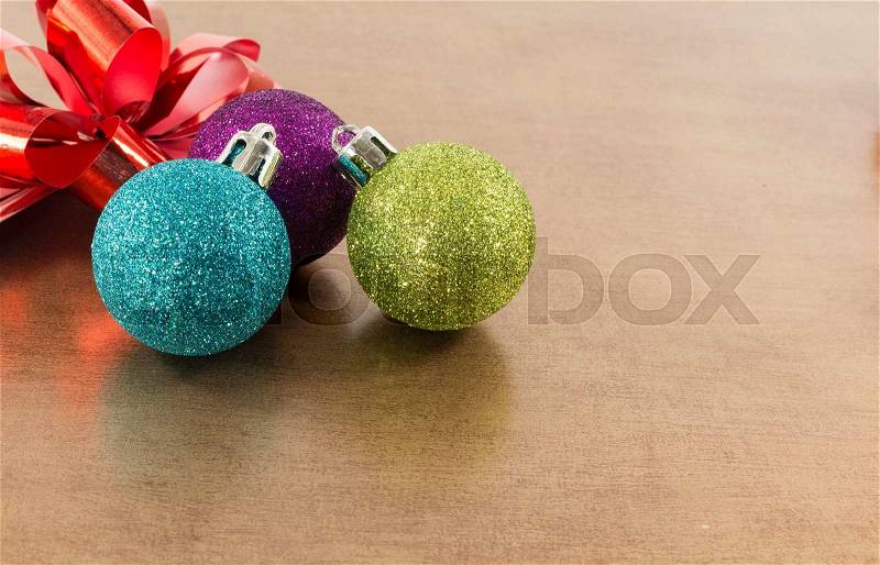 Blue,pink and green christmas balls on brown gold background, stock photo