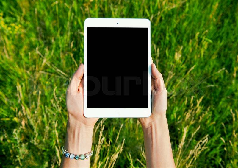 Female teen hands using tablet pc with black screen, stock photo