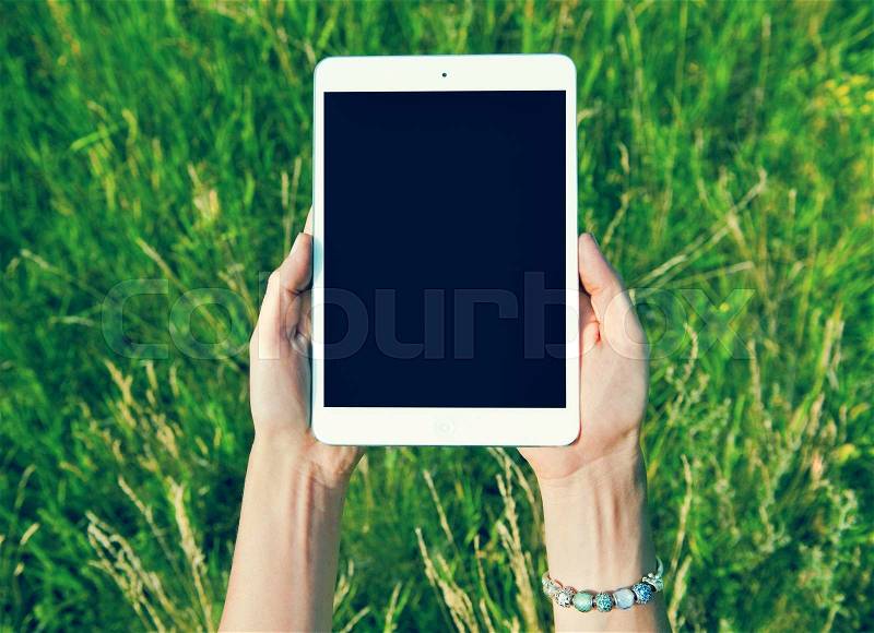 Female teen hands using tablet pc with black screen, stock photo