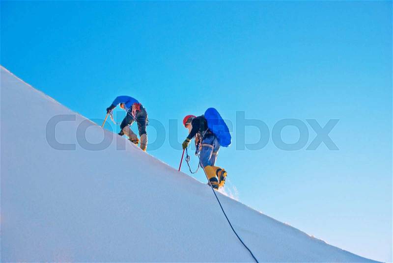 A group of climbers reaching the summit, stock photo
