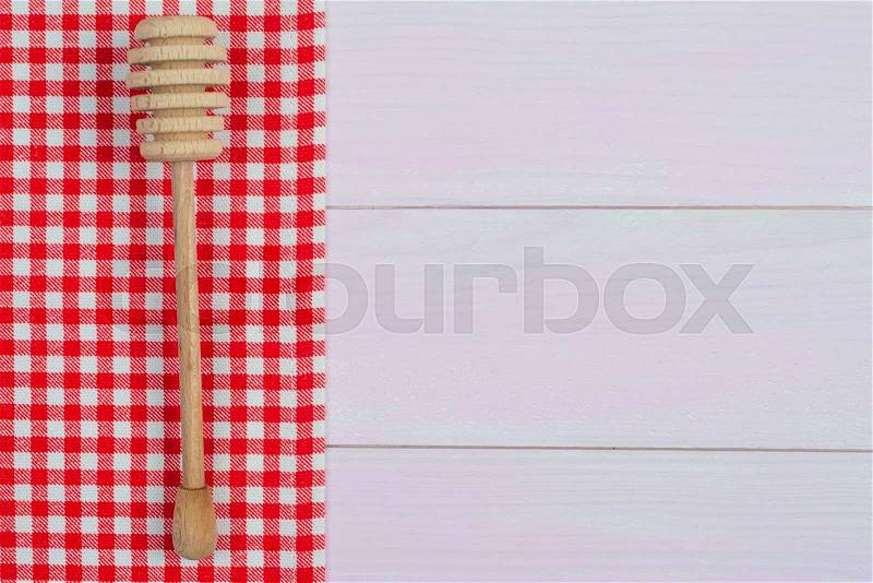 Kitchenware on white and red towel over wooden kitchen table. View from above, stock photo