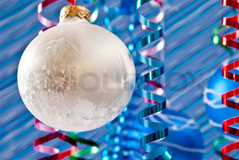 Christmas decoration from white and blue balls on blue background, stock photo