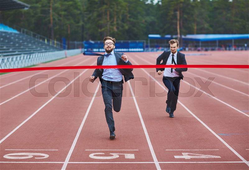 Successful businessman reaching finish and winning competition, stock photo