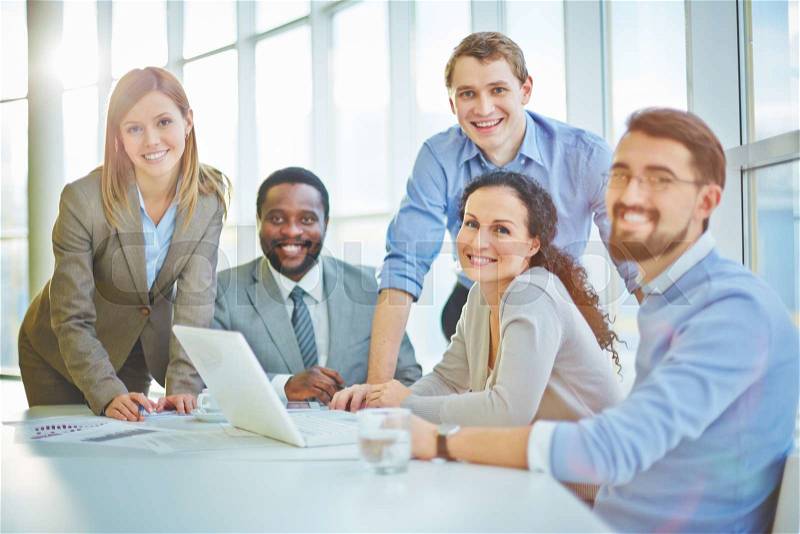 Modern business people sitting at workplace, stock photo