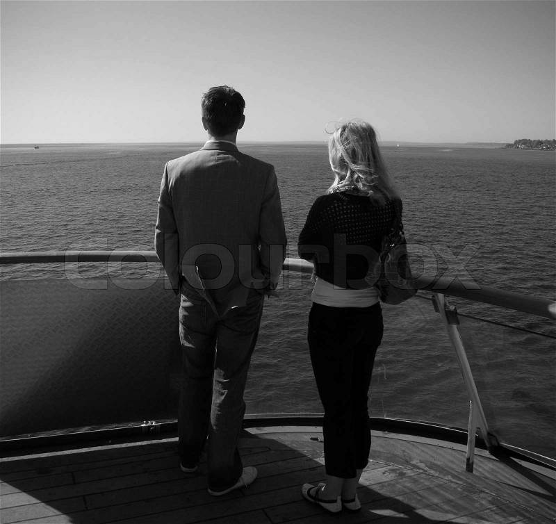 Young couple standing at a Danish ferry dreaming of a great future, stock photo