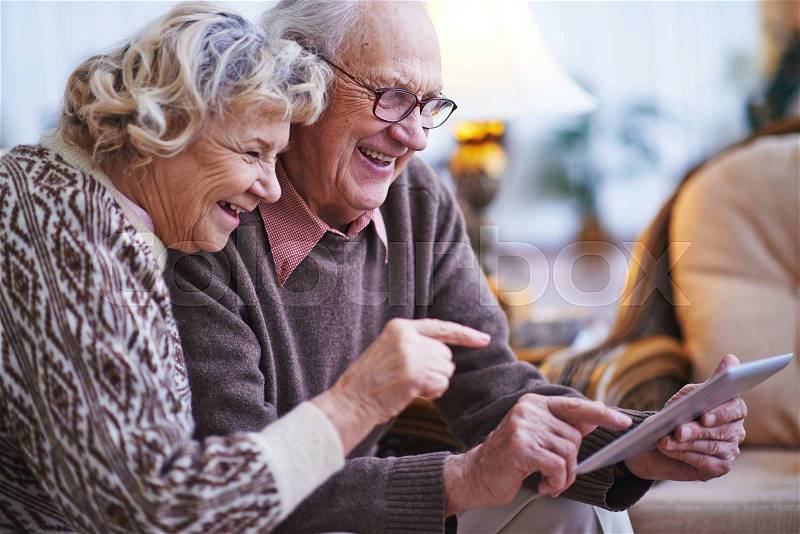 Happy seniors networking together at home, stock photo