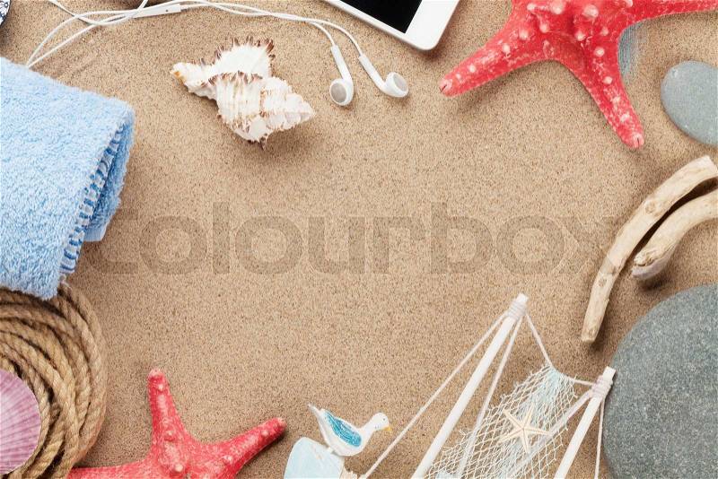 Travel and vacation items on sea sand. Top view with copy space, stock photo