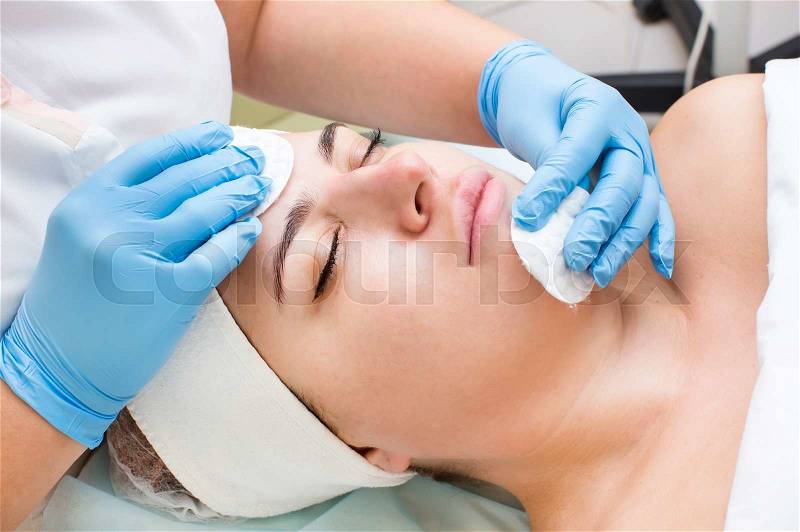 Woman passes treatment mask facial at the beauty salon, stock photo