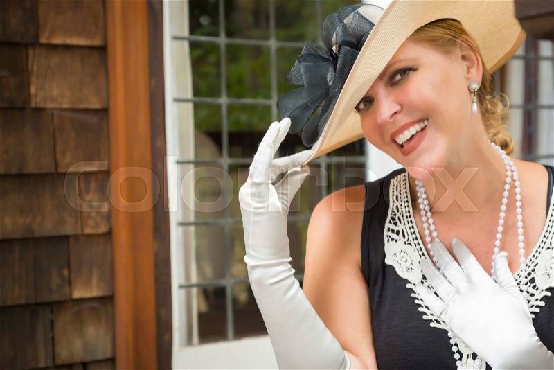 Attractive Young Woman in Twenties Outfit on Porch of an Antique House, stock photo