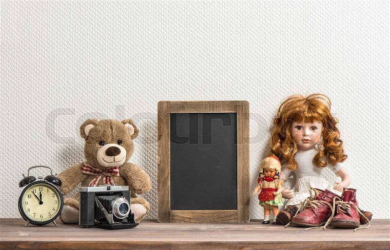 Doll, Teddy Bear, chalkboard and vintage toys. Retro style still life. No name toys, stock photo