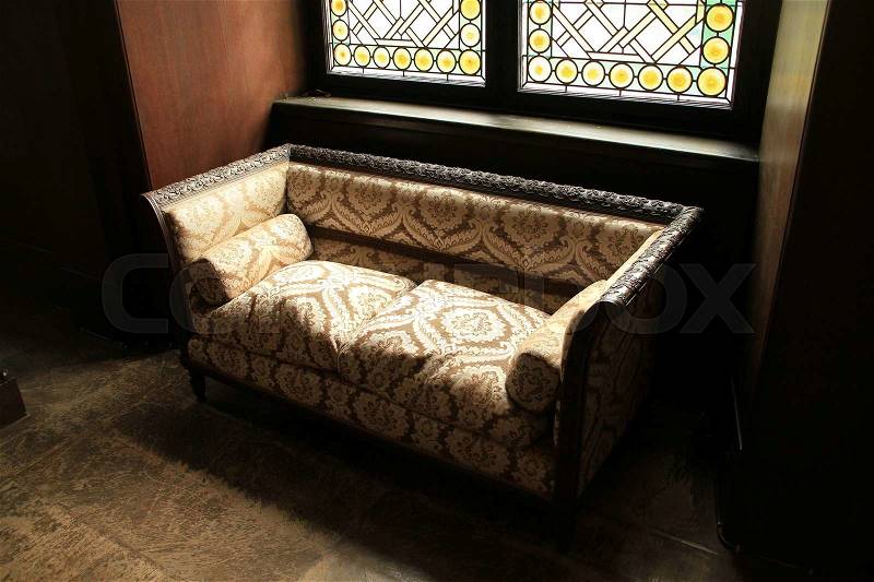Sunlight through the window and the couch is standing in one of the rooms in Reichsburg Cochem in Germany, stock photo