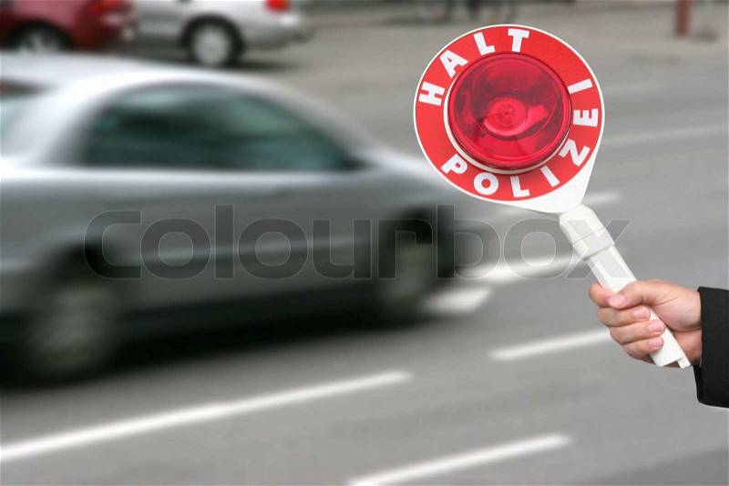 Traffic Ticket Police Vehicle - A police cruiser with the lights flashing has stopped a speeding car along the interstate highway and is issuing a ticket, stock photo