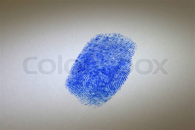 Magnifying glass over a blue digital print, stock photo