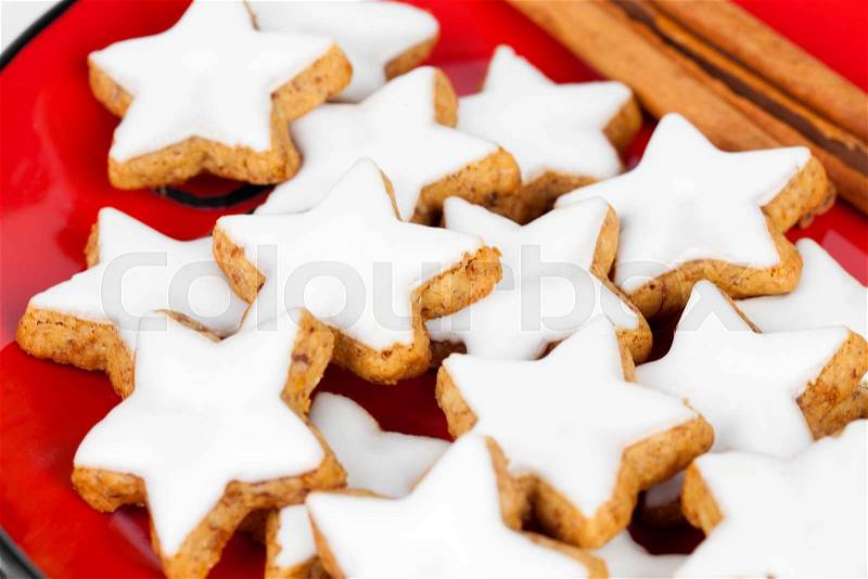 Christmas cinnamon star cookies on red plate, stock photo