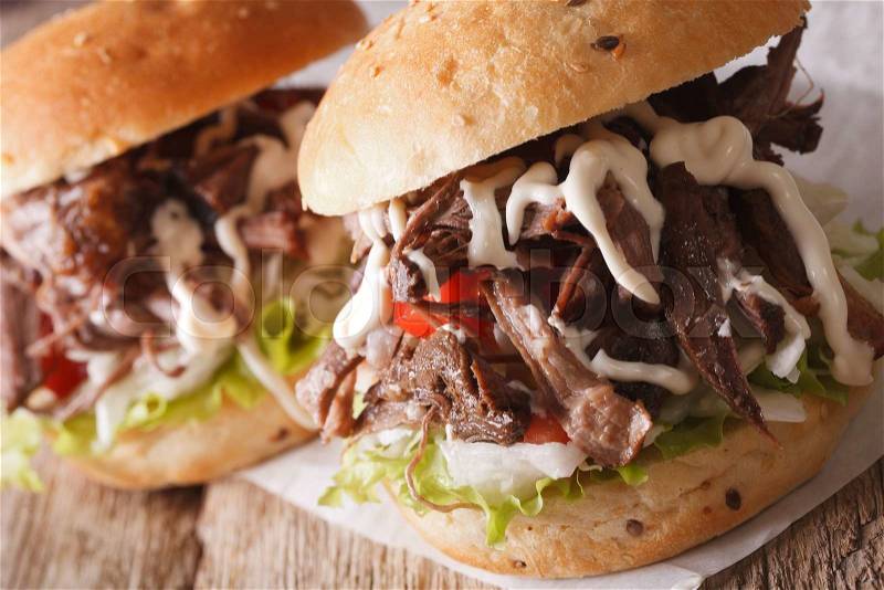 Hot Pulled pork sandwich with coleslaw and sauce close-up on the table. horizontal , stock photo