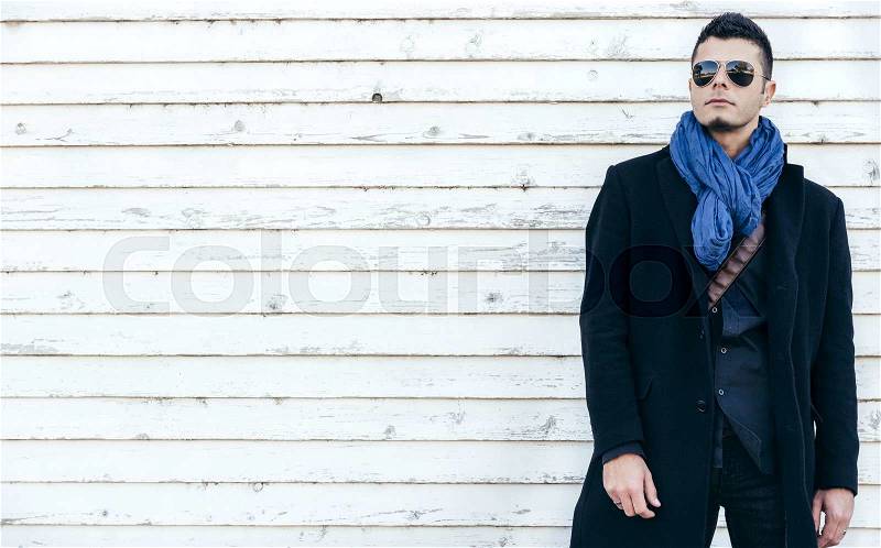 Photo with handsome man in coat on white wooden background with blank space,selective focus, stock photo