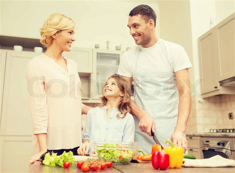 Food, family, hapiness and people concept - happy family making dinner in kitchen, stock photo