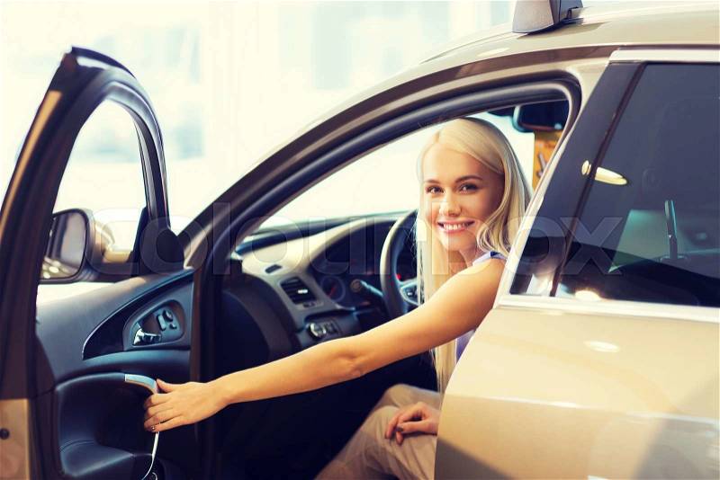 Auto business, car sale, consumerism , transportation and people concept - happy woman sitting in or driving car, stock photo
