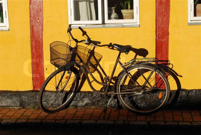 Bike Leaning on a Yellow Timberframed Wall, Svaneke, stock photo