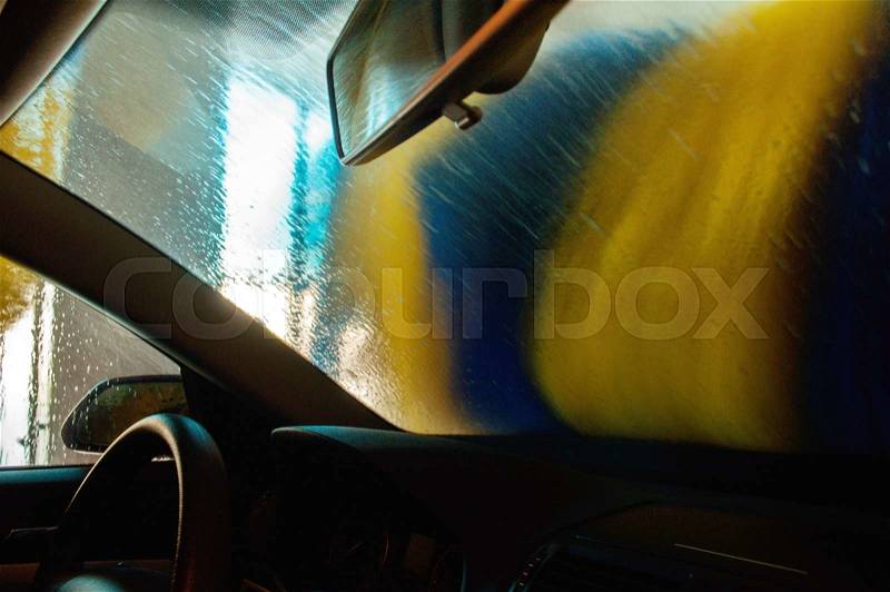 Car wash in action seen from the interior of a car, stock photo