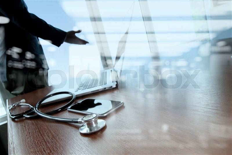 Doctor working with digital tablet and laptop computer in medical workspace office and medical network media diagram as concept, stock photo